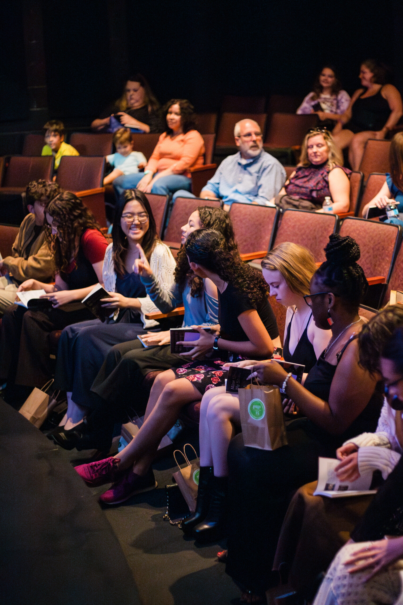 Young Authors smiling in a theater