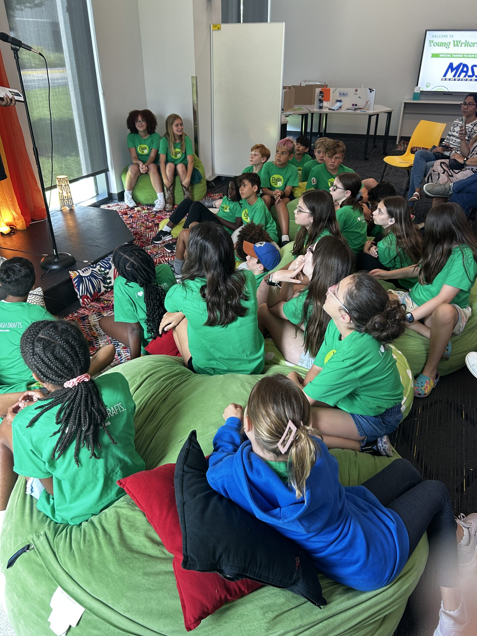 Page 15 members gathered and listening to a presenter